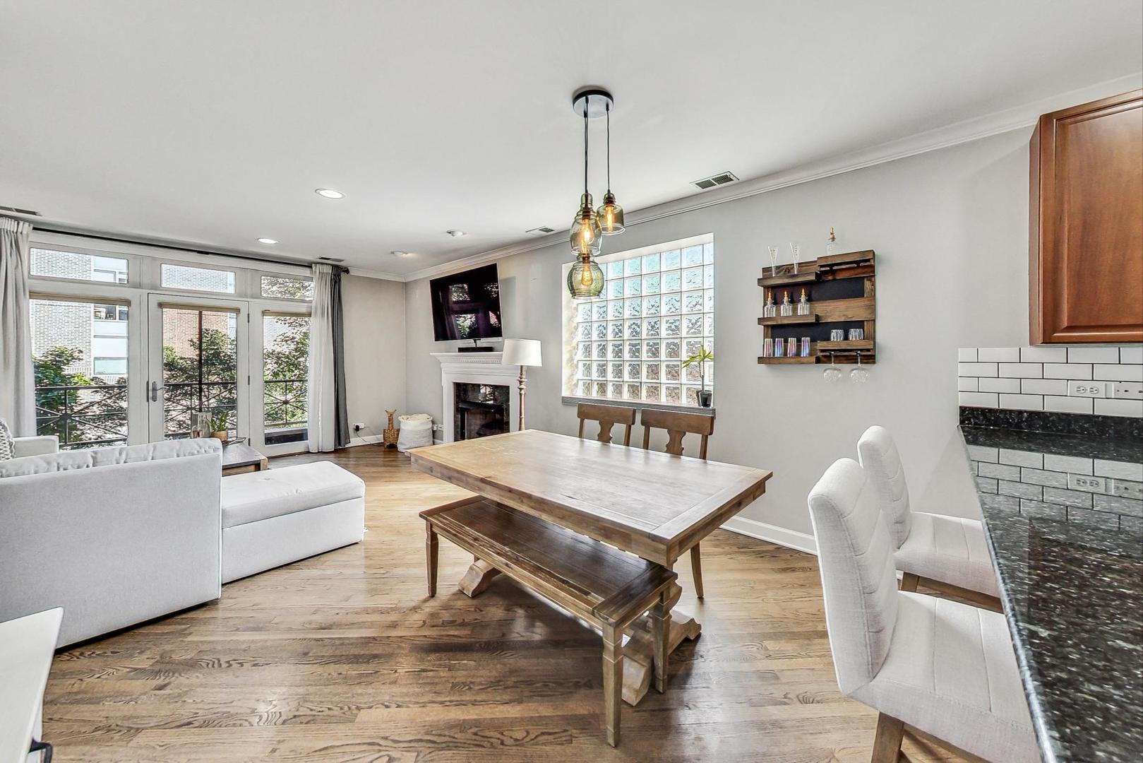 951 West Fletcher Street, Unit 2 Chicago, IL 60657 - Photo 6 of 26 a living room with furniture a table and chairs
