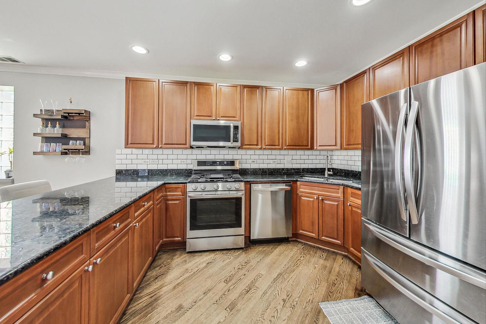 951 West Fletcher Street, Unit 2 Chicago, IL 60657 - Photo 8 of 26 a kitchen with stainless steel appliances granite countertop a refrigerator sink and stove