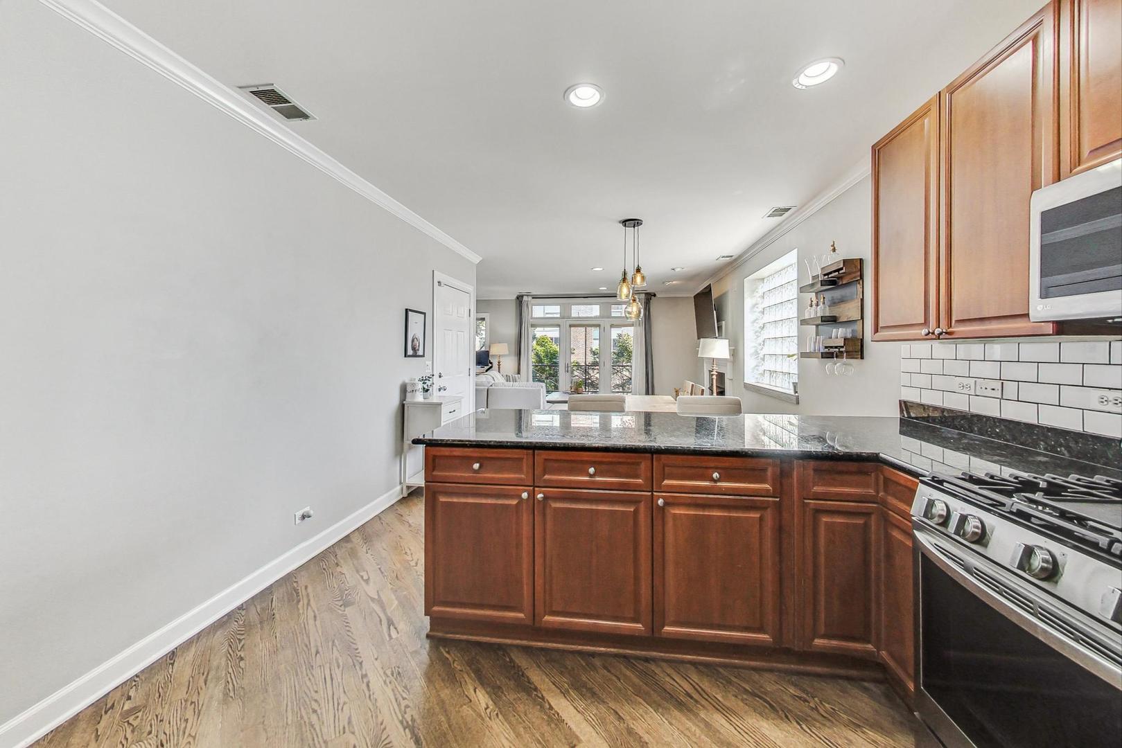951 West Fletcher Street, Unit 2 Chicago, IL 60657 - Photo 10 of 26 a kitchen with stainless steel appliances granite countertop a stove and a sink