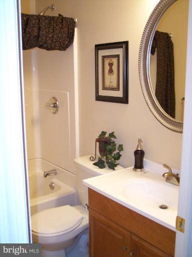 8575 Beacon Point Road Pasadena, MD 21122 - Photo 2 of 13 a bathroom with a sink a toilet and shower