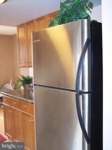 8575 Beacon Point Road Pasadena, MD 21122 - Photo 3 of 13 a white refrigerator freezer sitting in a kitchen