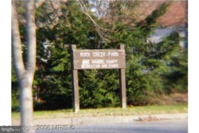 8575 Beacon Point Road Pasadena, MD 21122 - Photo 4 of 13 a sign that is sitting on the side of a road