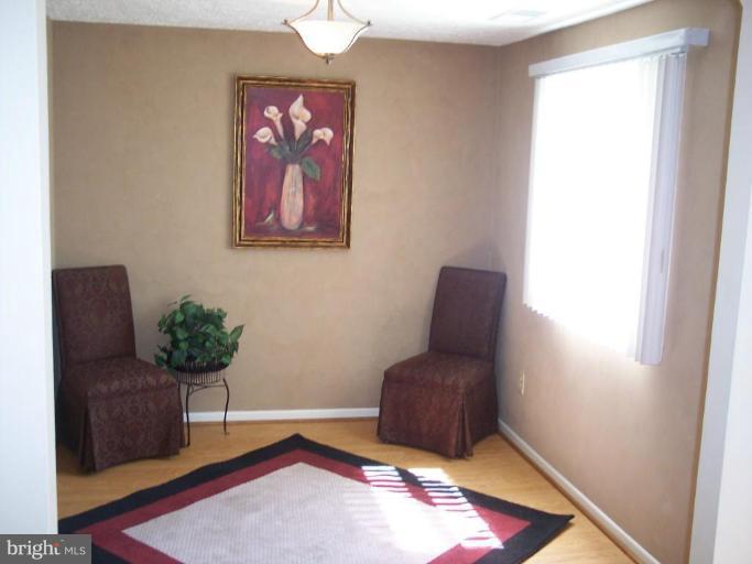 8575 Beacon Point Road Pasadena, MD 21122 - Photo 7 of 13 a living room with furniture and a potted plant