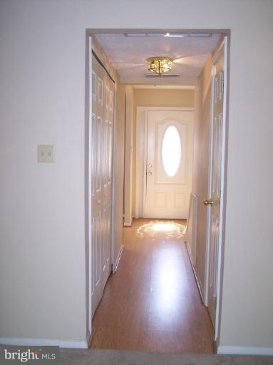 8575 Beacon Point Road Pasadena, MD 21122 - Photo 9 of 13 a view of a hallway with wooden floor