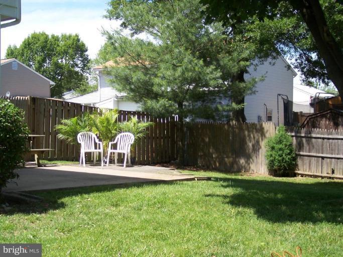 8575 Beacon Point Road Pasadena, MD 21122 - Photo 10 of 13 a view of a chair and table in backyard
