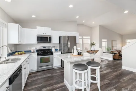 a kitchen with a stove a sink and a refrigerator
