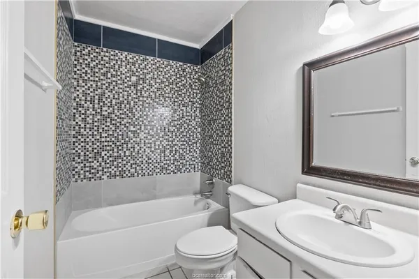 a bathroom with a bathtub and a sink