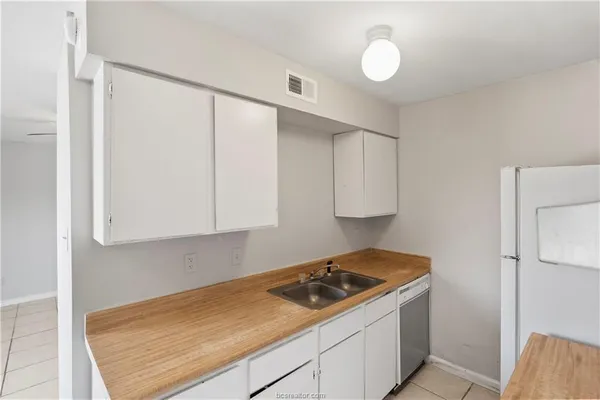 a kitchen with a stove and a refrigerator