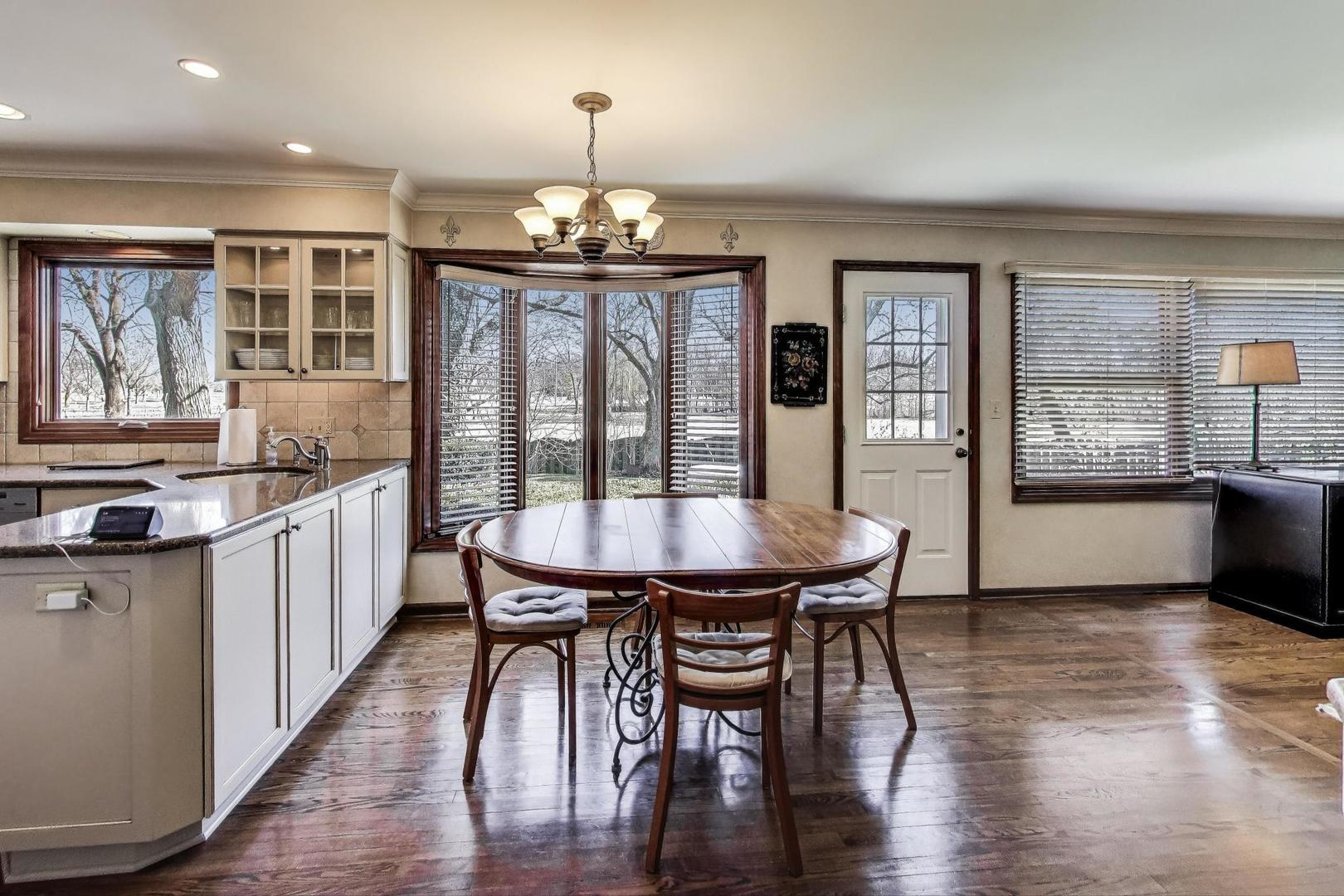 2207 North Brighton Place Arlington Heights, IL 60004 - Photo 11 of 37 a view of a dining room with furniture window and wooden floor