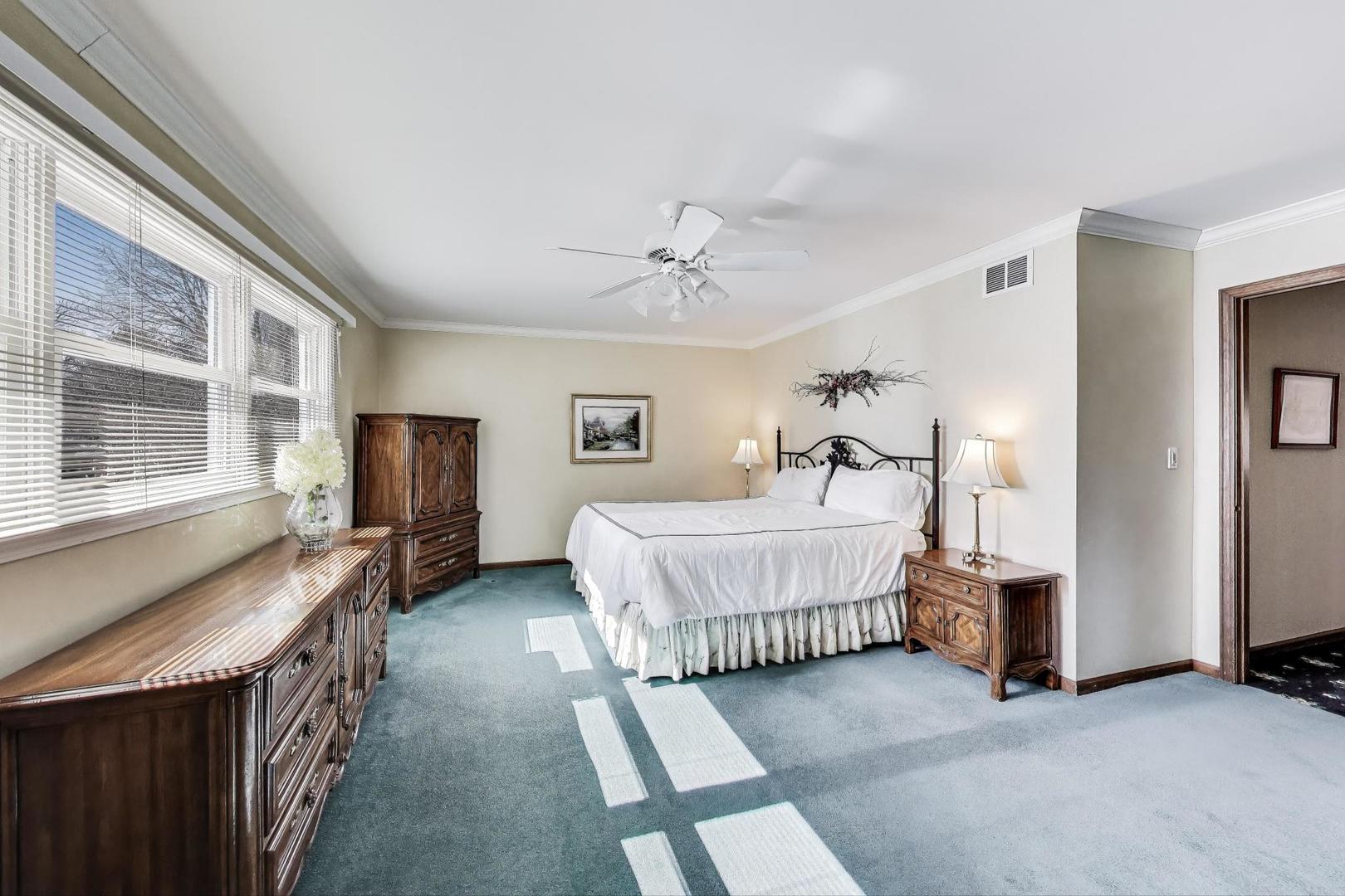 2207 North Brighton Place Arlington Heights, IL 60004 - Photo 17 of 37 a bedroom with a bed and a chandelier