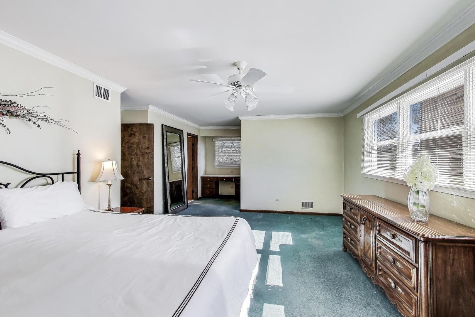 2207 North Brighton Place Arlington Heights, IL 60004 - Photo 18 of 37 a spacious bedroom with a bed and a chandelier