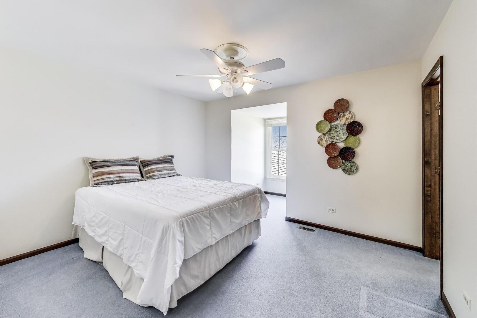 2207 North Brighton Place Arlington Heights, IL 60004 - Photo 20 of 37 a bedroom with a bed and a chandelier