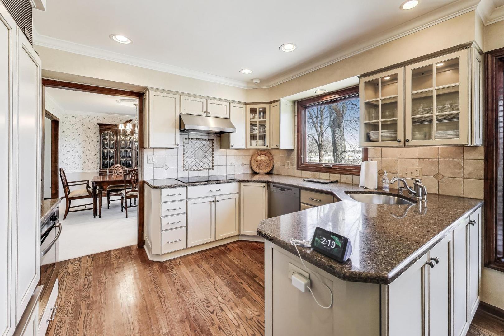 2207 North Brighton Place Arlington Heights, IL 60004 - Photo 7 of 37 a kitchen with stainless steel appliances granite countertop a sink a stove and a wooden floors