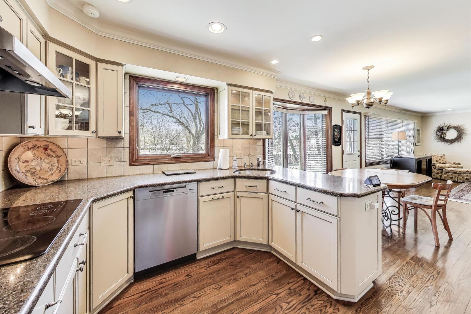 2207 North Brighton Place Arlington Heights, IL 60004 - Photo 8 of 37 a kitchen with stainless steel appliances granite countertop a stove and cabinets