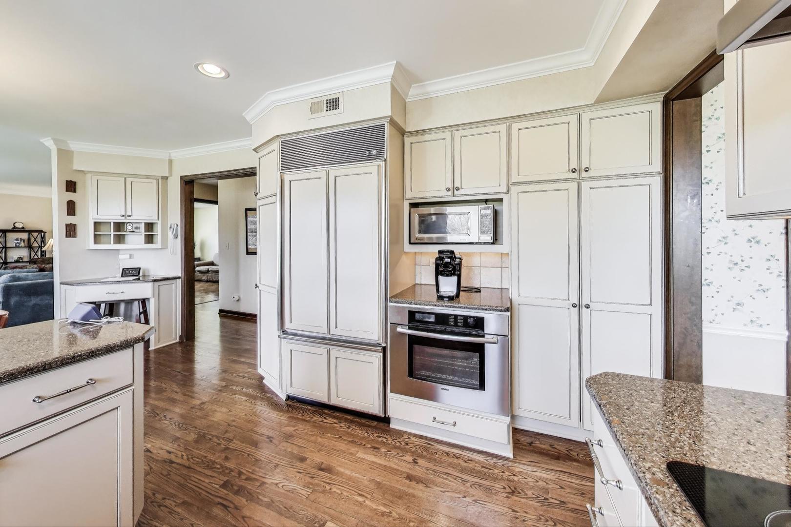 2207 North Brighton Place Arlington Heights, IL 60004 - Photo 9 of 37 a kitchen with stainless steel appliances a refrigerator sink and cabinets