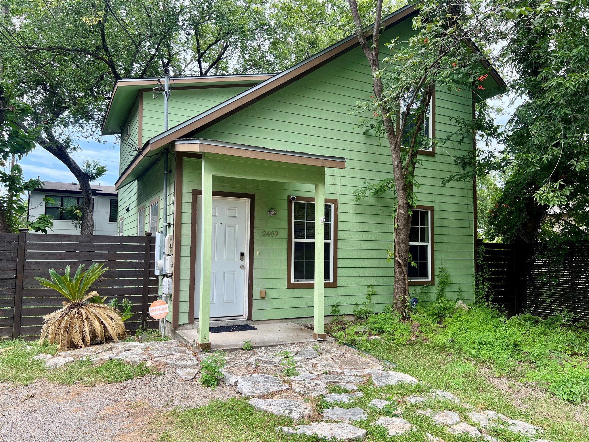 2409 Santa Rosa Street Austin, TX 78702 - Photo 1 of 19 A charming two-story home with a stone pathway leading to the inviting front entrance.