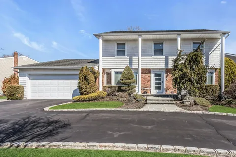 a view of a house with a yard and sitting area