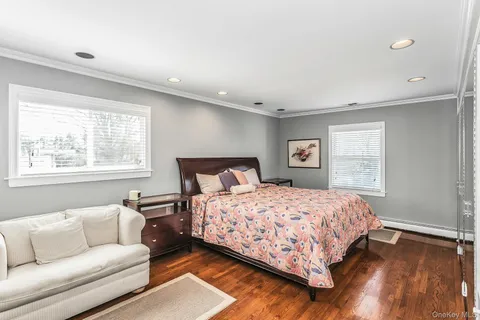 a bedroom with a bed couch and window