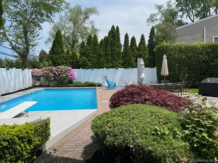 a view of garden with flowers and trees