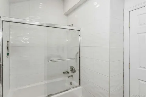 a bathroom with a shower and a bath tub