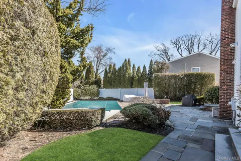 a view of a garden with a building in the background