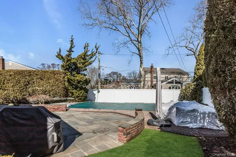 a view of backyard with swimming pool and outdoor seating
