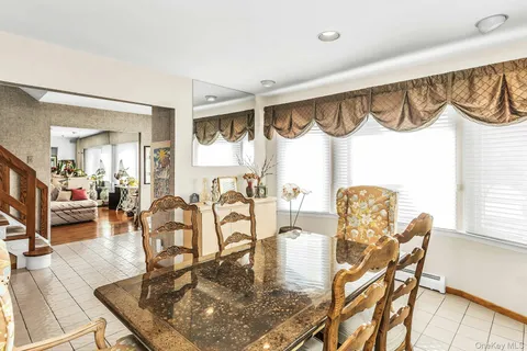 a dining room with furniture a rug and wooden floor