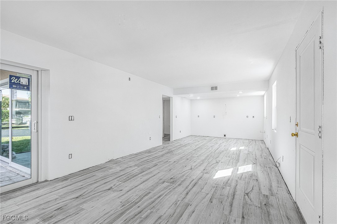 16881 Davis Road, Unit 412 Fort Myers, FL 33908 - Photo 12 of 27 wooden floor in an empty room