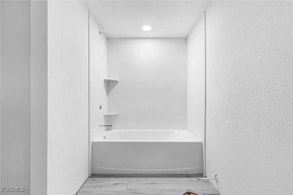 a bathroom with bathtub and shower