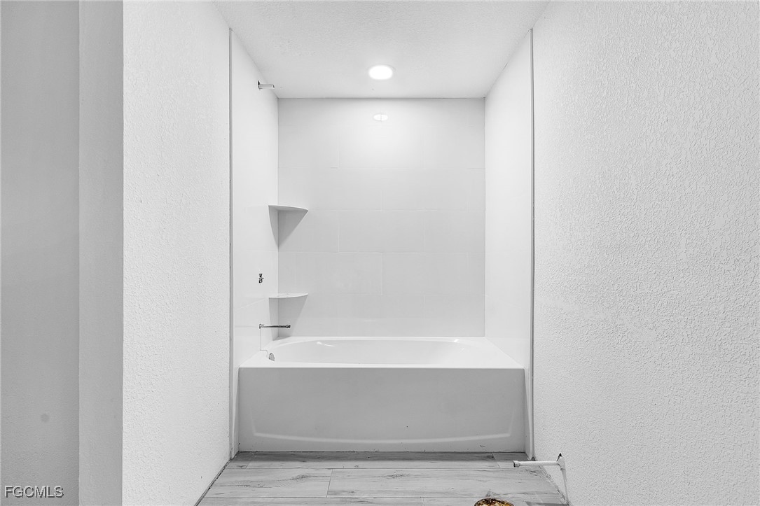 16881 Davis Road, Unit 412 Fort Myers, FL 33908 - Photo 14 of 27 a bathroom with bathtub and shower
