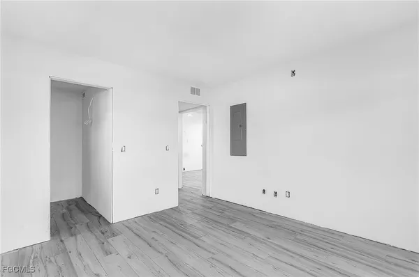 a view of a room with wooden floor