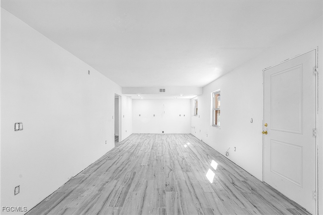 16881 Davis Road, Unit 412 Fort Myers, FL 33908 - Photo 9 of 27 a view of an empty room with wooden floor