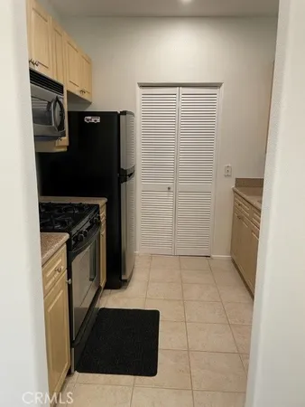 a kitchen with a refrigerator stove and cabinets