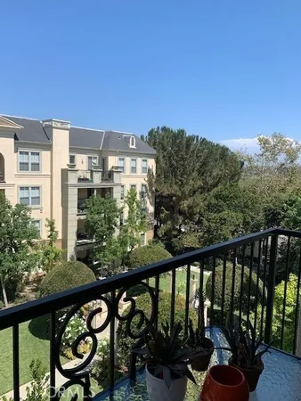 a view of a balcony with chairs and wooden floor