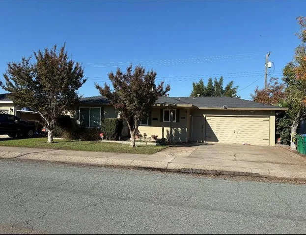 a view of a house with a yard and tree s