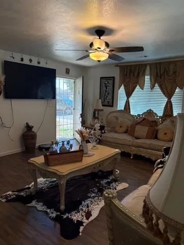 a living room with furniture and a chandelier