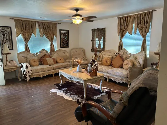 a living room with furniture a rug and a chandelier