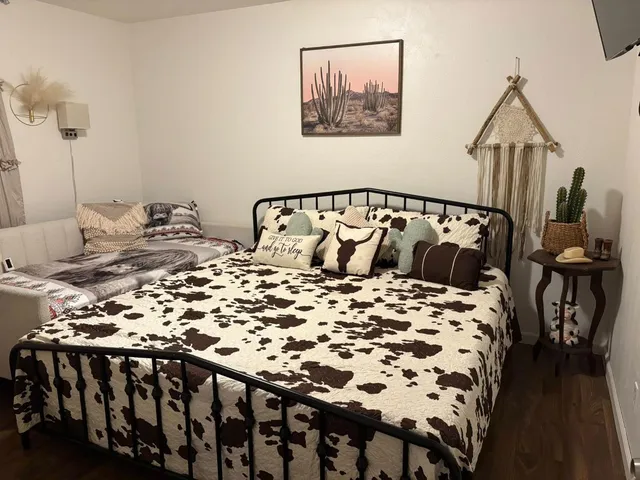 a bedroom with a bed and wooden floor