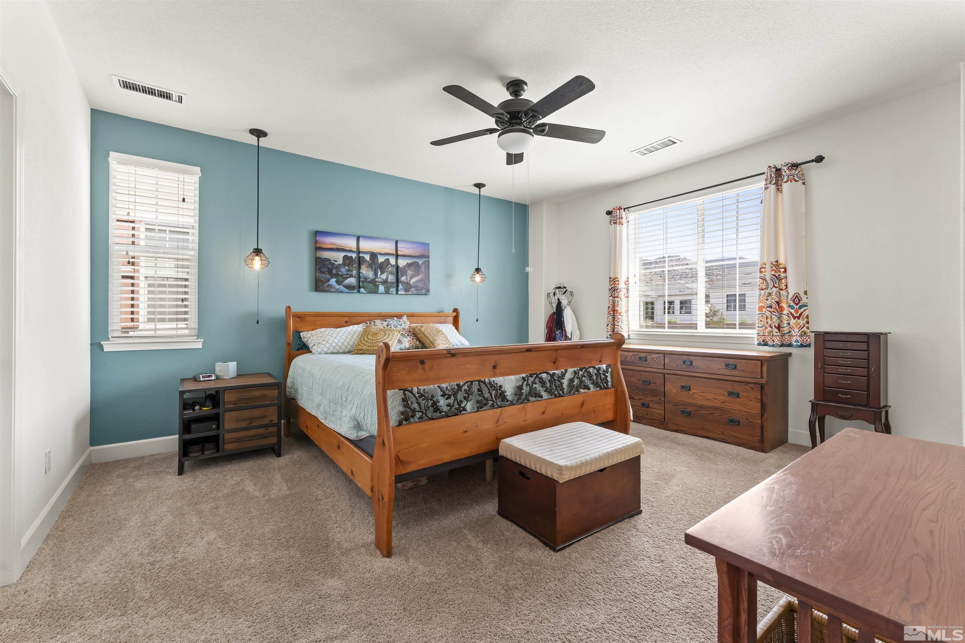 2082 Whitecliff Drive Reno, NV 89521 - Photo 17 of 40 a bedroom with a bed and a dresser in it