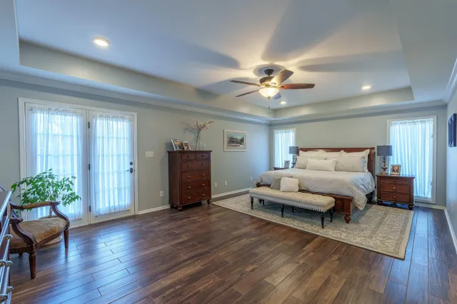 a spacious bedroom with a bed and a chandelier