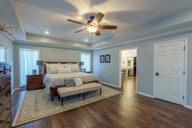 a living room with stainless steel appliances furniture a refrigerator and a sink