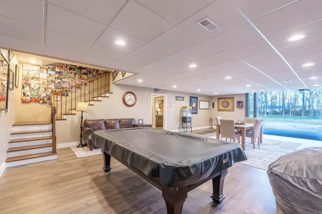 a dining room with furniture and wooden floor