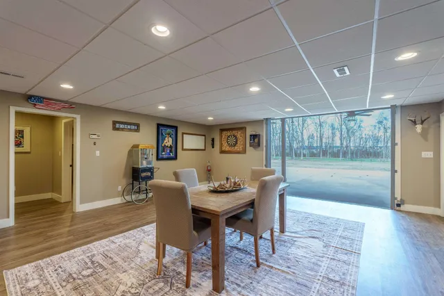 a dining room with furniture and wooden floor