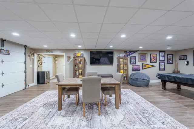 a kitchen with stainless steel appliances granite countertop a table chairs sink refrigerator and cabinets