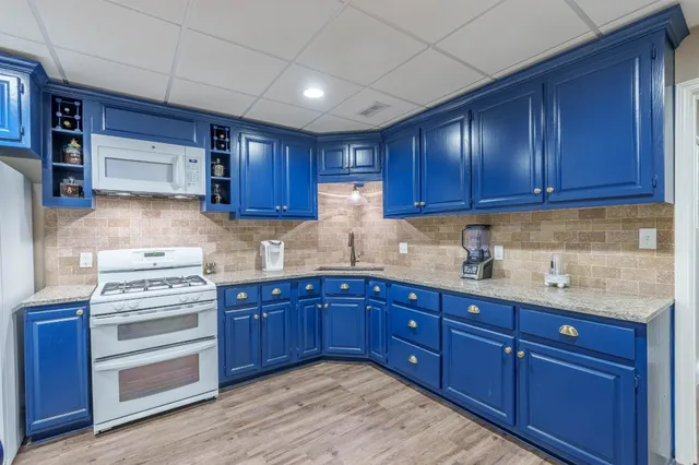 a kitchen with wooden cabinets