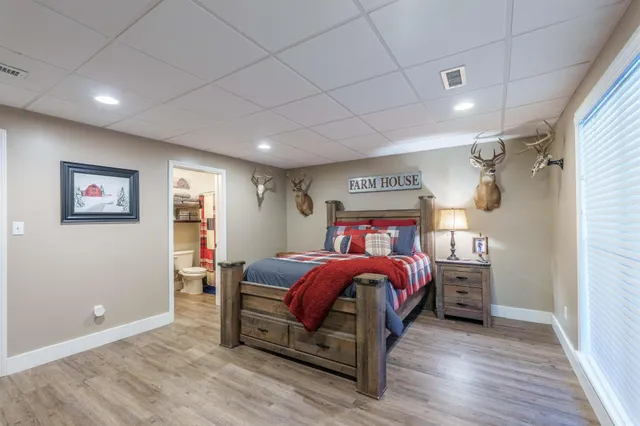 a bathroom with a granite countertop toilet sink and mirror