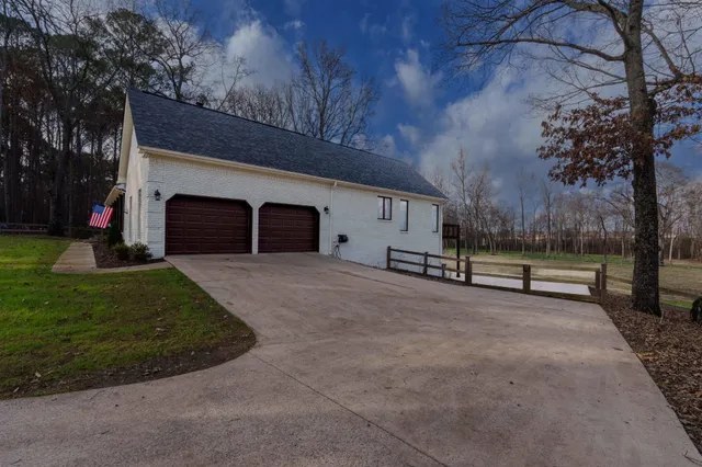 a view of a house with a yard and garage