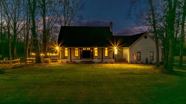 a view of swimming pool is middle in the grass