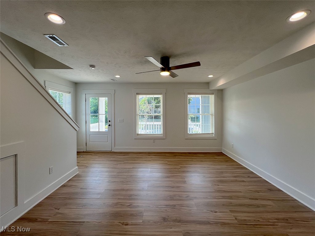 3641 Menlo Road Cleveland, OH 44120 - Photo 4 of 26 Open concept dining/living room with recessed lighting, bank of front windows, light wood-style floors, open stairway and ceiling fan