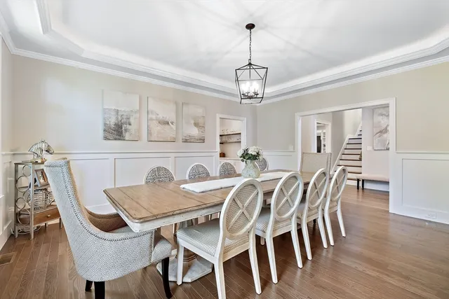 a view of a dining room with furniture wooden floor and chandelier